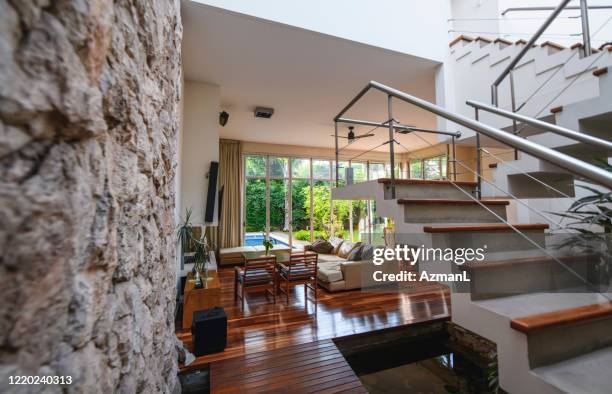 spacious modern home interior with stairs to second floor - stone wall garden stock pictures, royalty-free photos & images