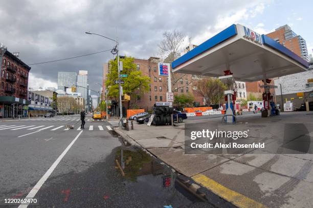 The view of an empty gas station on a deserted street amid the coronavirus pandemic on April 21, 2020 in New York City, United States. COVID-19 has...