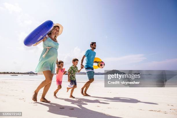 carefree family having fun in summer day on the beach. - kids fun indonesia stock pictures, royalty-free photos & images