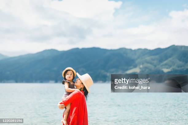 mother and daughter relaxed in the beach - asian on beach stock pictures, royalty-free photos & images