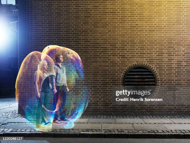 young couple in soapbubbles - big city life stock pictures, royalty-free photos & images