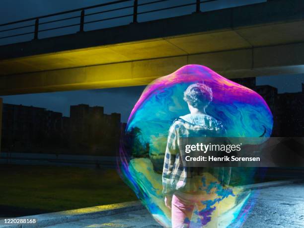 young male in soapbubble - big bubble stock-fotos und bilder