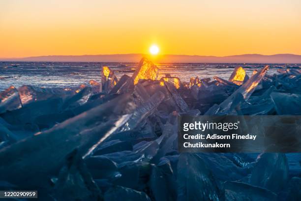 colorful sunset over the crystal ice of baikal lake. - crystal caves stockfoto's en -beelden