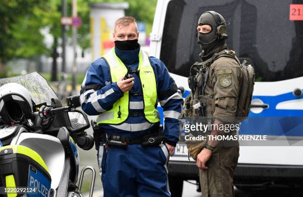 Police officers are seen guarding the Higher Regional Court in Frankfurt am Main on June 16, 2020 for the start of the trial of the accused of...