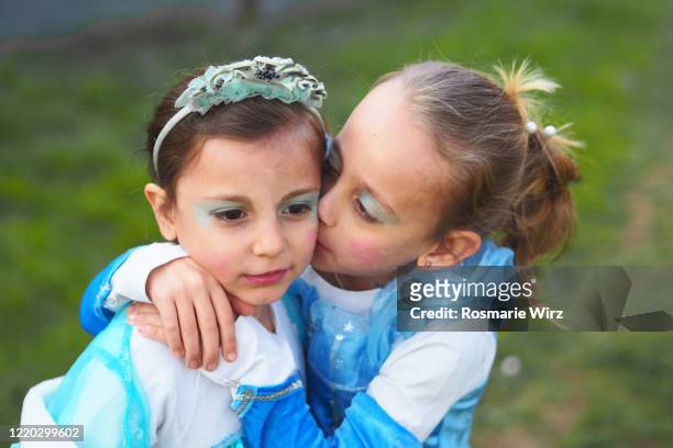 two girls wearing princess dresses kissing - royalty free stock pictures, royalty-free photos & images