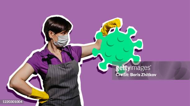 mid adult woman wearing hygiene mask, apron and protective gloves holding coronavirus. - homemaker - fotografias e filmes do acervo