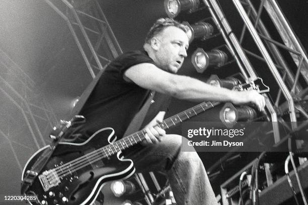 Peter Hook of New Order performs live on stage at Finsbury Park, on June 9, 2002 in London, England.