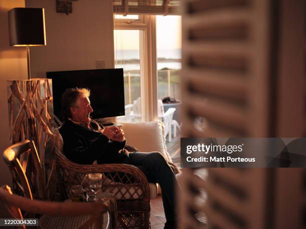 senior male enjoying an evening drink at home - loneliness home stock pictures, royalty-free photos & images