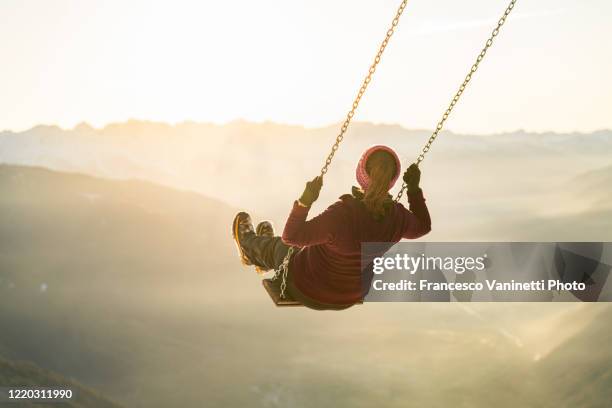 woman on a swing. - woman on swing stock pictures, royalty-free photos & images