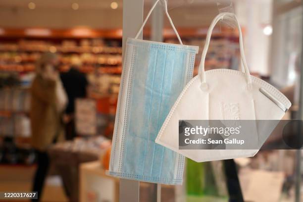Surgical mask and an N95 mask hang on display for sale at a pharmacy during the novel coronavirus crisis on April 22, 2020 in Berlin, Germany....