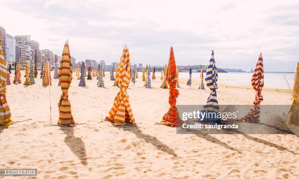 beach huts collected in san lorenzo beach - beach club stock pictures, royalty-free photos & images