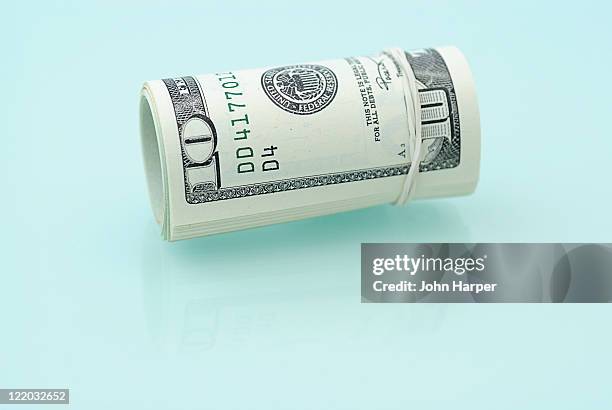 roll of american dollars. - ten us dollar note stock pictures, royalty-free photos & images