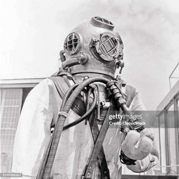 1960s industrial deep sea diver standard diving dress suit and equipment often called hard-hat copper hat or heavy gear