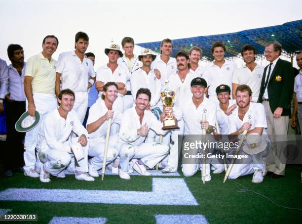 Australia captain Allan Border holds the trophy with Geoff Marsh as the rest of the team and management celebrate after Australia had beaten England...