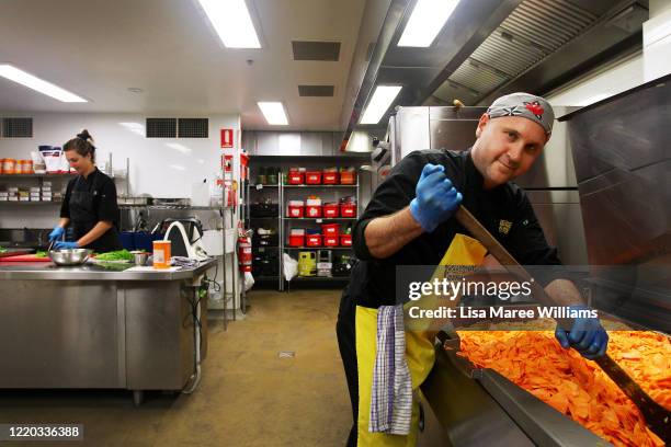 Chef Giovanni Lo Surdo and Lauren Evers prepare food at OzHarvest HQ on April 22, 2020 in Sydney, Australia. Founded in 2014, food rescue charity...