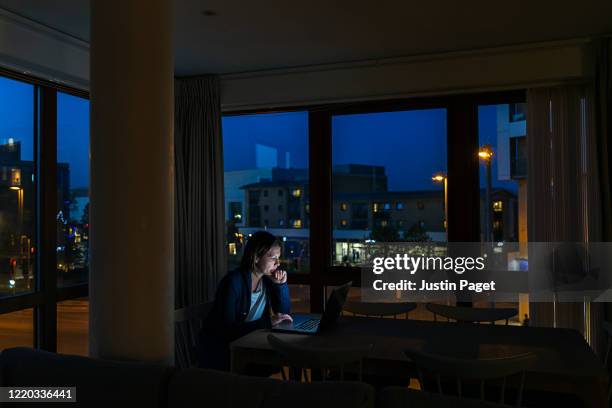 woman working from home at night - opening night of the boy from oz arrivals and after party stockfoto's en -beelden