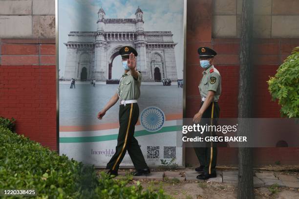Two Chinese paramilitary police officers patrol outside the Indian embassy in Beijing on June 16, 2020. - China on June 16 accused India of crossing...