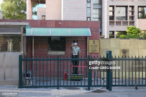 Chinese paramilitary police officer stands guard at an entrance to the Indian embassy in Beijing on June 16, 2020. - China on June 16 accused India...