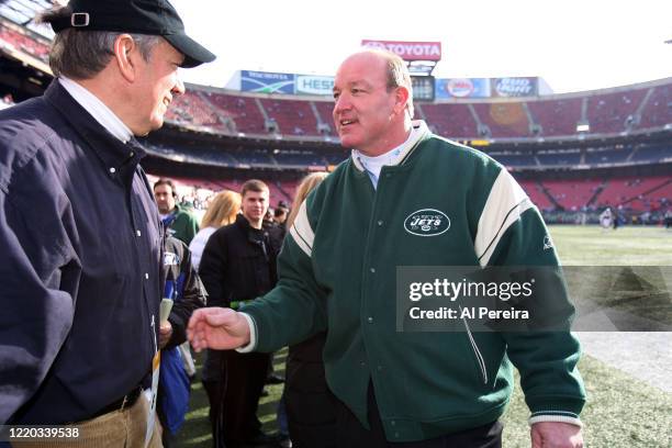 New York State Governor George Pataki speaks with New York Jets alumni player and radio host Marty Lyons when he attends the New York Jets vs the...