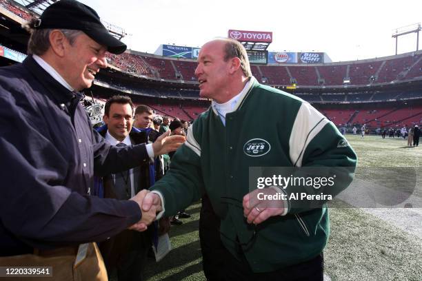 New York State Governor George Pataki speaks with New York Jets alumni player and radio host Marty Lyons when he attends the New York Jets vs the...