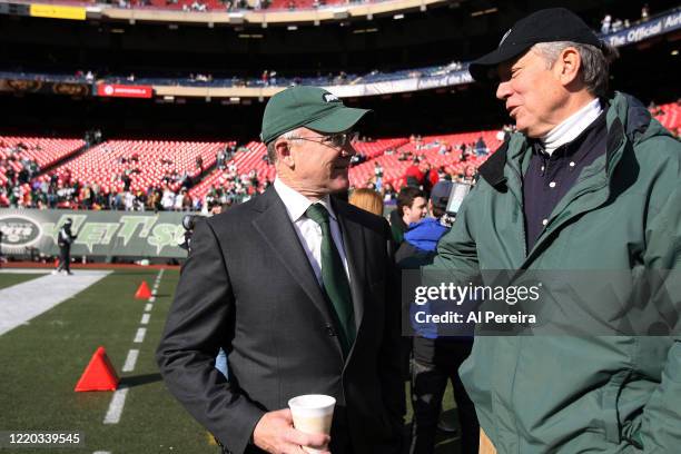 New York State Governor George Pataki speaks with New York Jets Owner Woody Johnson when he attends the New York Jets vs the Oakland Raiders game at...