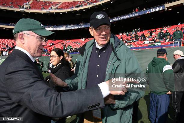 New York State Governor George Pataki speaks with New York Jets Owner Woody Johnson when he attends the New York Jets vs the Oakland Raiders game at...