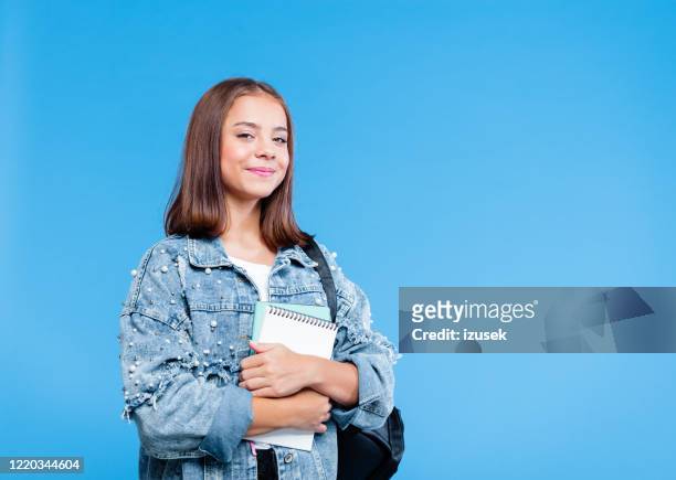 portrait of female high school student holding notebooks - school pride stock pictures, royalty-free photos & images