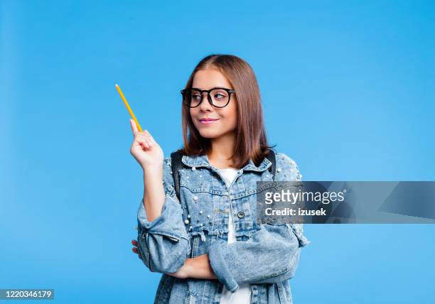 portrait of petty teenage girl holding pensil - child pointing stock pictures, royalty-free photos & images