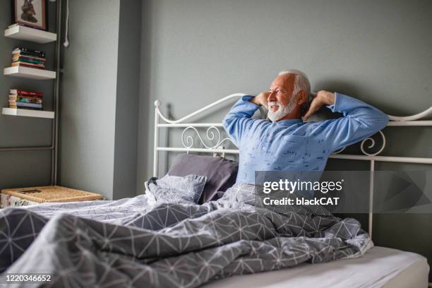 senior man waking up - waking up in bed stock pictures, royalty-free photos & images