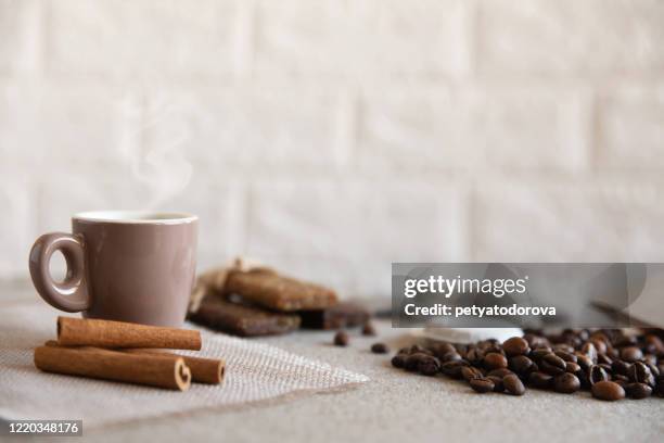 cup of coffee, protein bars, roasted coffee beans and cinnamon sticks - coffee capsules stock pictures, royalty-free photos & images