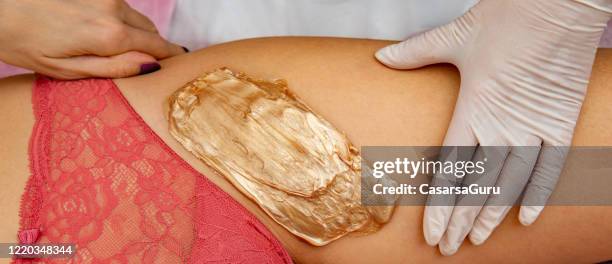 waiting for wax to be ready for peeling off from client's skin - stock photo - pêlo pubiano imagens e fotografias de stock