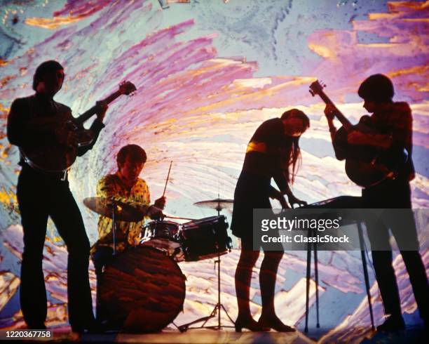 1960s 1970s anonymous silhouetted teen rock band girl on keyboard with guitars and drums swirly blue pink psychedelic background