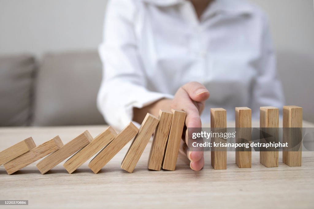 Business man placing wooden block on a tower concept risk control, Planning and strategy in business.Alternative risk concept,Risk To Make Buiness Growth Concept With Wooden Blocks