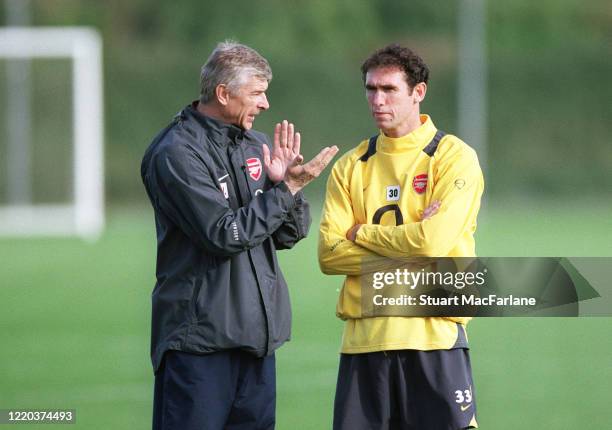 Arsene Wenger the Arsenal Manager chats to Martin Koewn during an Arsenal Training Session on November 1, 2005 in St. Albans, England.