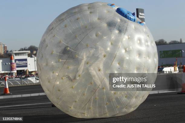 Former England cricketer Andrew "Freddie" Flintoff runs inside a zorb as he attempts to break the fastest 100m zorbing world record in North London...