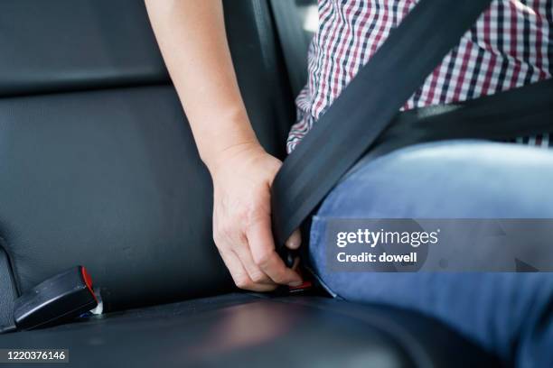 fastening safety belt in car - seatbelt stock pictures, royalty-free photos & images