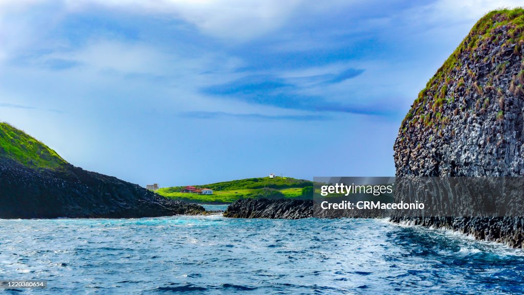 Boat trip through the Bay of Santo Antonio. In front of São José Island and in the background ruins and buildings, including the Chapel of São Pedro dos Pescadores.