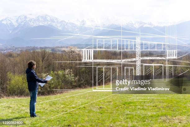 mid age man holding blueprint - anticipation stock pictures, royalty-free photos & images
