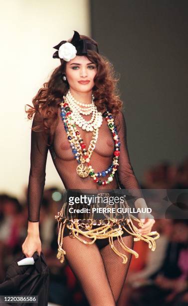 Model presents a transparent body suit worn under a chain mini-skirt by German designer Karl Lagerfeld of Chanel during the 91/92 Fall/Winter...