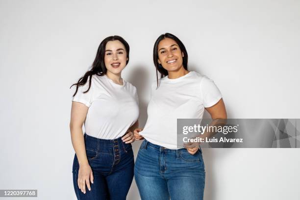 portrait of a two plus sized women standing together - white tshirt stock pictures, royalty-free photos & images