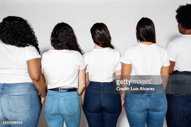 rear view of multi-ethnic group of women together - posteriore foto e immagini stock