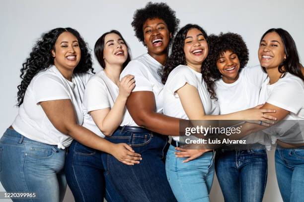 group of cheerful women with different body size - white jeans stock pictures, royalty-free photos & images