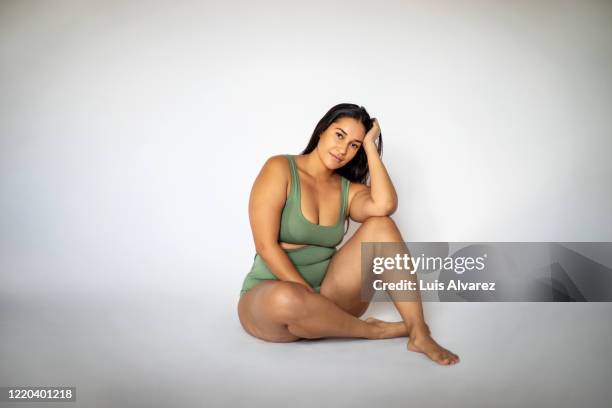 beautiful oversize woman in lingerie sitting on floor - buxom women ストックフォトと画像