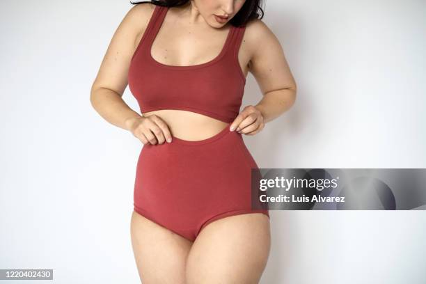 chubby woman in lingerie on white background - voluptuoso fotografías e imágenes de stock