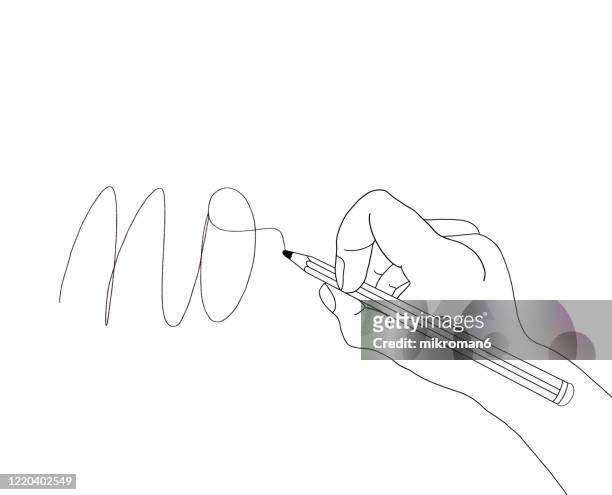 hand holding a pencil and drawing word no - hand written letter ストックフォトと画像