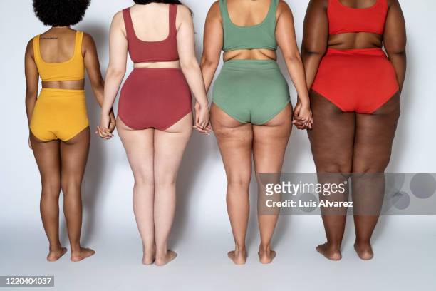 rear view of multi-ethnic females in lingerie - cul photos et images de collection