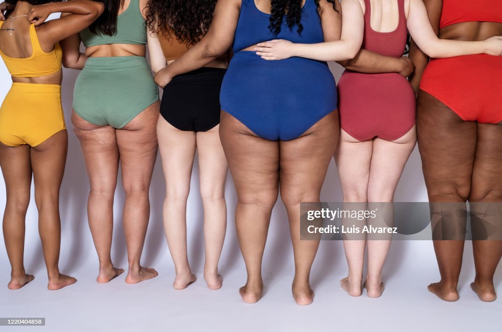 Rear view of a diverse females together in underwear