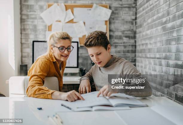 mother helping son with homework - homeschooling stock pictures, royalty-free photos & images