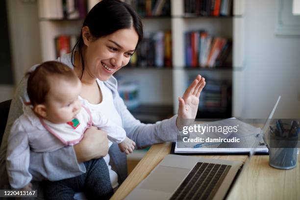 mother having video conference - distant meeting stock pictures, royalty-free photos & images