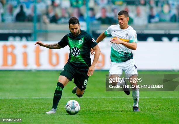 Wolfsburg's Swiss midfielder Renato Steffen and Moenchengladbach's Stefan Moenchengladbach's Austrian defender Stefan Lainer vie for the ball during...